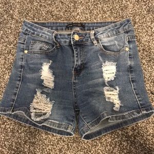 High-rise dark blue denim shorts with rips